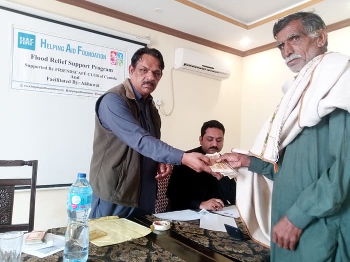 A family collecting their flood relief payment