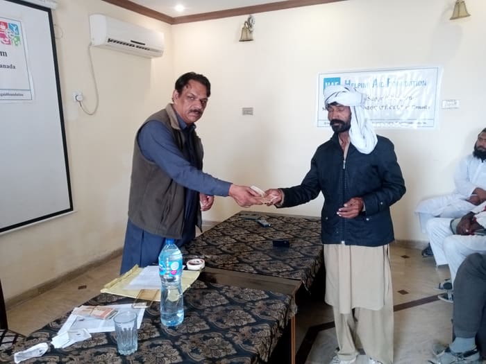 A recipient collecting their household's flood relief payment