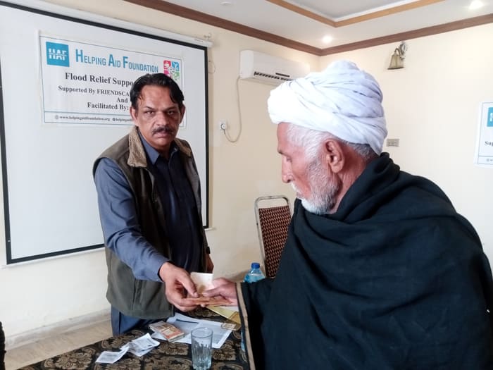 A recipient collecting their household's flood relief payment