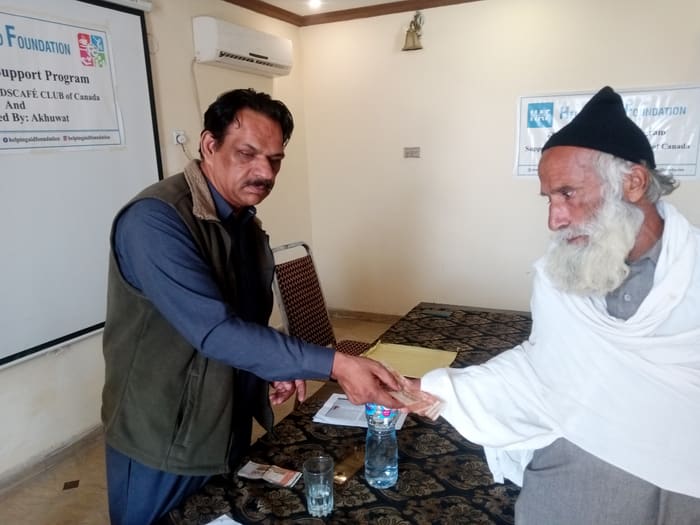 A recipient collecting their household's flood relief payment