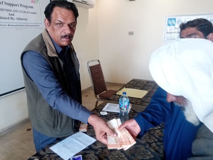 A recipient collecting their household's flood relief payment