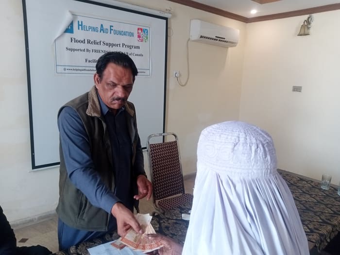 A recipient collecting their household's flood relief payment