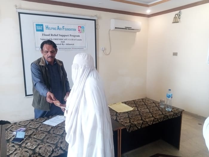A recipient collecting their household's flood relief payment