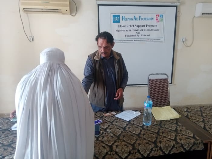A recipient collecting their household's flood relief payment